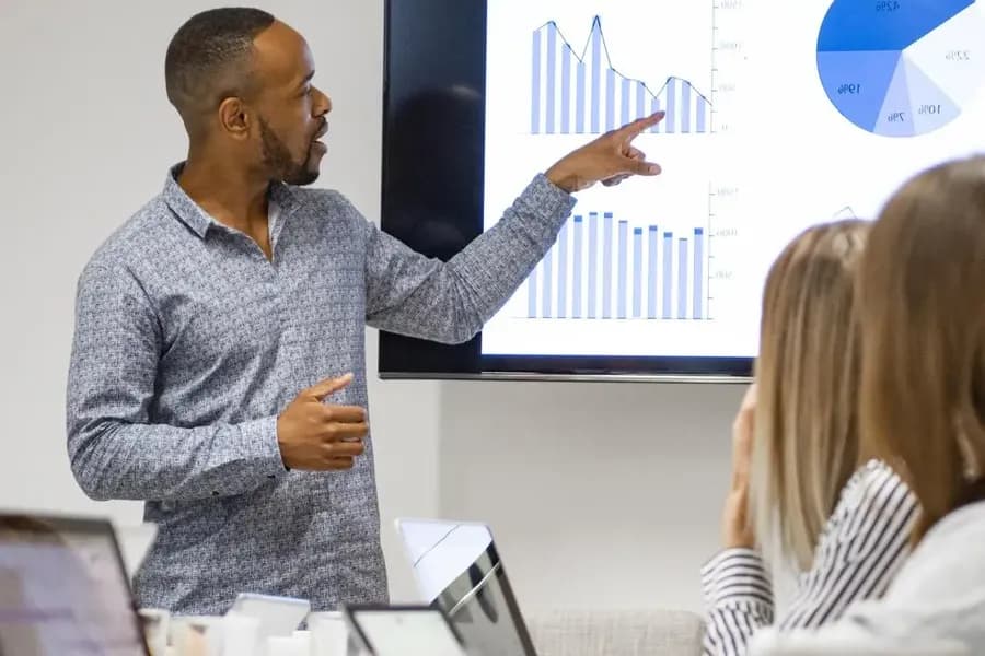 Man reviewing graphs of data in a meeting
